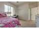 Bedroom featuring a bed, desk, large window, and closet with sliding doors at 5712 French Lace Ct, North Las Vegas, NV 89081