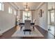 Elegant dining room with stylish lighting, a large table, and neutral décor for entertaining guests at 5712 French Lace Ct, North Las Vegas, NV 89081