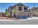 Two-story home with a stucco exterior, three-car garage, tile roof, and a small balcony at 5712 French Lace Ct, North Las Vegas, NV 89081