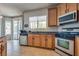 Functional kitchen with stainless steel appliances, tile flooring and access to the backyard through sliding glass doors at 5712 French Lace Ct, North Las Vegas, NV 89081