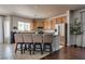 Bright kitchen features wooden cabinets, stainless steel appliances, and a breakfast bar with four stools at 5712 French Lace Ct, North Las Vegas, NV 89081