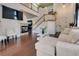 Open concept living area with a fireplace, staircase, and comfortable seating for relaxation at 5712 French Lace Ct, North Las Vegas, NV 89081