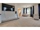 Open main bedroom layout featuring a seating area, vanity, and large windows with dark curtains at 5712 French Lace Ct, North Las Vegas, NV 89081