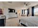 Bright and airy main bedroom with a king-size bed, large windows and a ceiling fan at 5712 French Lace Ct, North Las Vegas, NV 89081