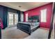 Cozy main bedroom with a large bed, dark curtains, and access to a private balcony at 5712 French Lace Ct, North Las Vegas, NV 89081