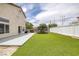 Spacious backyard featuring artificial grass, patio area, and privacy fencing at 5816 Glory Canyon Way, Las Vegas, NV 89142