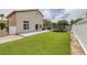 Spacious backyard featuring a well-maintained artificial lawn, concrete patio, privacy fence and trampoline at 5816 Glory Canyon Way, Las Vegas, NV 89142