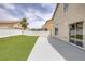 Large backyard with artificial grass, extended patio, and secure fencing at 5816 Glory Canyon Way, Las Vegas, NV 89142