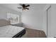 Cozy bedroom with a large window, fan, and neutral wall color at 5816 Glory Canyon Way, Las Vegas, NV 89142