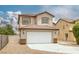 Two-story home featuring a neutral-toned facade, tile roof, two-car garage, and low maintenance landscaping at 5816 Glory Canyon Way, Las Vegas, NV 89142