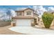 Exterior view of a two-story residence featuring a tile roof and an attached two-car garage at 5816 Glory Canyon Way, Las Vegas, NV 89142