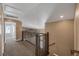 Upstairs hallway with wood railing and neutral carpeting at 5816 Glory Canyon Way, Las Vegas, NV 89142