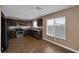 Open kitchen featuring stainless steel appliances, granite countertops, and dark wood cabinets at 5816 Glory Canyon Way, Las Vegas, NV 89142