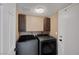 Convenient laundry room featuring gray washer and dryer and storage cabinets at 5816 Glory Canyon Way, Las Vegas, NV 89142