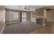 Spacious living room with a fireplace, ceiling fan and large window at 5816 Glory Canyon Way, Las Vegas, NV 89142