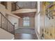 Entryway into a living room that features an open staircase, wood ceiling beam details, and neutral-colored walls at 5816 Glory Canyon Way, Las Vegas, NV 89142