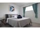 Bedroom with a plush bed with blue accents, comfortable linens, and a bright window at 6432 Bannock Way, Las Vegas, NV 89107