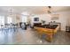 Open living space with pool table, dining area, and ample natural light at 6432 Bannock Way, Las Vegas, NV 89107