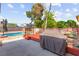 Backyard features an inviting pool, deck area, and mature trees at 6612 Elton Ave, Las Vegas, NV 89107