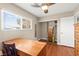 Bright bedroom featuring wood-look floors, ceiling fan and large window at 6612 Elton Ave, Las Vegas, NV 89107