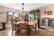 Charming dining room with wooden table, chairs, china cabinet, and natural light from a window at 6612 Elton Ave, Las Vegas, NV 89107