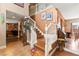 Welcoming two-story foyer boasts hardwood floors, a staircase with white railings, and charming decor at 6612 Elton Ave, Las Vegas, NV 89107