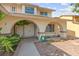 Inviting entryway with an arched doorway, double doors, and desert landscaping creating a warm welcome at 6612 Elton Ave, Las Vegas, NV 89107