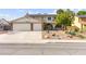 Charming home with a basketball hoop over the garage, a well-manicured lawn, and desert landscaping at 6612 Elton Ave, Las Vegas, NV 89107