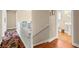 Bright hallway with white banister and colorful rug leading to the bathroom at 6612 Elton Ave, Las Vegas, NV 89107