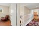 Hallway with white banister, colorful rug, and a comfortable chair at 6612 Elton Ave, Las Vegas, NV 89107