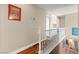 Upstairs hallway featuring white railing and colorful runner at 6612 Elton Ave, Las Vegas, NV 89107