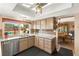 Bright kitchen with stainless steel appliances, granite countertops, and a view of the pool at 6612 Elton Ave, Las Vegas, NV 89107