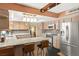 Eat-in kitchen featuring granite countertops, stainless steel appliances, and a cozy breakfast bar at 6612 Elton Ave, Las Vegas, NV 89107