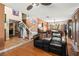 Open-concept living area with hardwood floors, staircase, and adjoining dining area at 6612 Elton Ave, Las Vegas, NV 89107