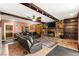 Comfortable living room with a striking stone fireplace, ceiling fan and wood beam accents at 6612 Elton Ave, Las Vegas, NV 89107