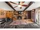 Inviting living room features a stone fireplace, wood beams, and built-in shelving perfect for cozy evenings at 6612 Elton Ave, Las Vegas, NV 89107