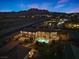 Majestic aerial view of the sprawling property showcasing the swimming pool, patio, and picturesque mountain backdrop at 670 Du Fort Ave, Henderson, NV 89002
