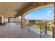 Expansive covered balcony overlooks the pool, manicured backyard and scenic mountain views at 670 Du Fort Ave, Henderson, NV 89002