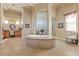 Bathroom boasts a large jacuzzi tub with tile surround and separate shower at 670 Du Fort Ave, Henderson, NV 89002