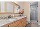 Bathroom featuring granite countertop, wood cabinets and a tiled glass door shower at 670 Du Fort Ave, Henderson, NV 89002