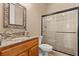 A traditional bathroom with a marble vanity, wood cabinets, and a tiled glass shower enclosure at 670 Du Fort Ave, Henderson, NV 89002