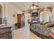 Spacious bedroom with stone-accented fireplace, ceiling fan, and tile floors at 670 Du Fort Ave, Henderson, NV 89002