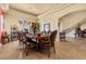 Elegant dining room with decorative ceilings, a beautiful table setting, and ornamental staircase at 670 Du Fort Ave, Henderson, NV 89002