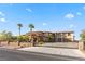 Luxurious home behind a secure gate, surrounded by mature trees and desert landscaping at 670 Du Fort Ave, Henderson, NV 89002