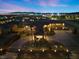 Striking aerial view of the home at twilight showcasing the illuminated facade, landscape lighting, and grand entrance at 670 Du Fort Ave, Henderson, NV 89002