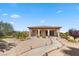 Charming home exterior featuring a landscaped yard, covered walkway, and a serene desert setting at 670 Du Fort Ave, Henderson, NV 89002
