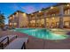 Luxury home featuring a large pool, covered patio, and elegant architectural details at 670 Du Fort Ave, Henderson, NV 89002