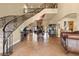 Grand foyer with staircase and wrought iron railing at 670 Du Fort Ave, Henderson, NV 89002