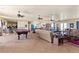 An open game room is furnished with a pool table, comfortable sofas, and a wet bar at 670 Du Fort Ave, Henderson, NV 89002