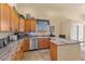 Bright eat-in kitchen featuring granite countertops, modern appliances, and wood cabinetry at 670 Du Fort Ave, Henderson, NV 89002